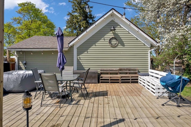deck with outdoor dining space, area for grilling, and an outdoor hangout area
