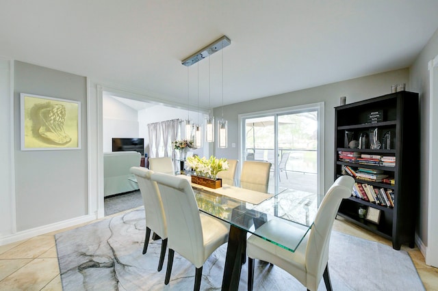 dining area featuring light tile patterned floors and baseboards