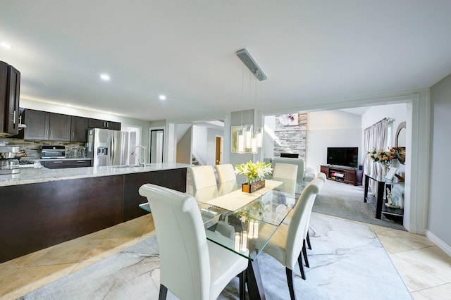 dining room featuring stairs, recessed lighting, a fireplace, and light tile patterned floors