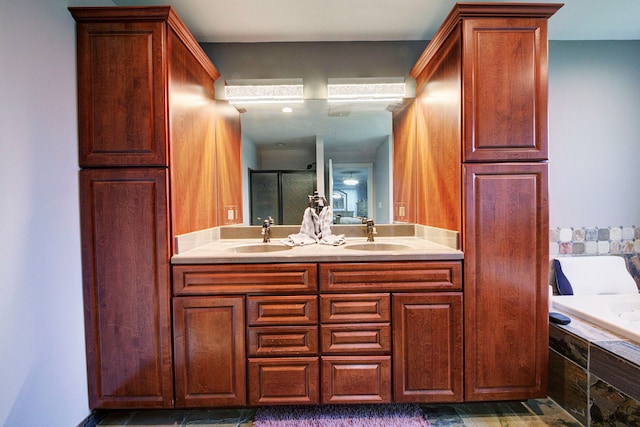 bathroom featuring a stall shower, double vanity, and a garden tub