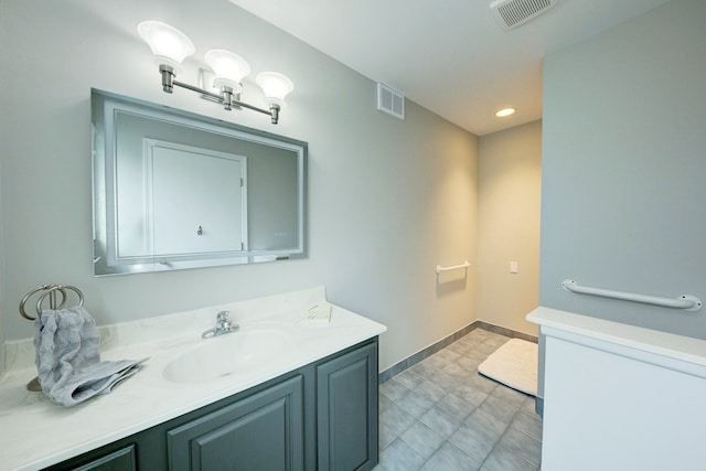 bathroom with vanity, baseboards, and recessed lighting