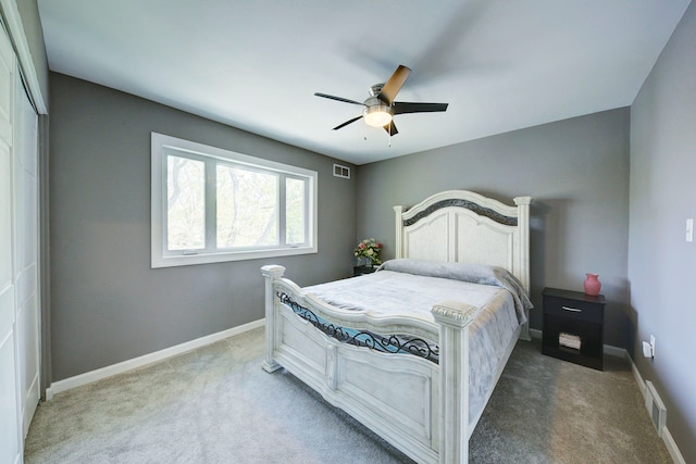 carpeted bedroom with baseboards, ceiling fan, and a closet