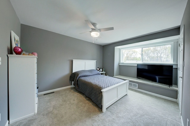 bedroom with light carpet, baseboards, and ceiling fan