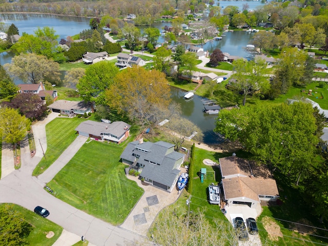 aerial view of property's location featuring a large body of water and nearby suburban area