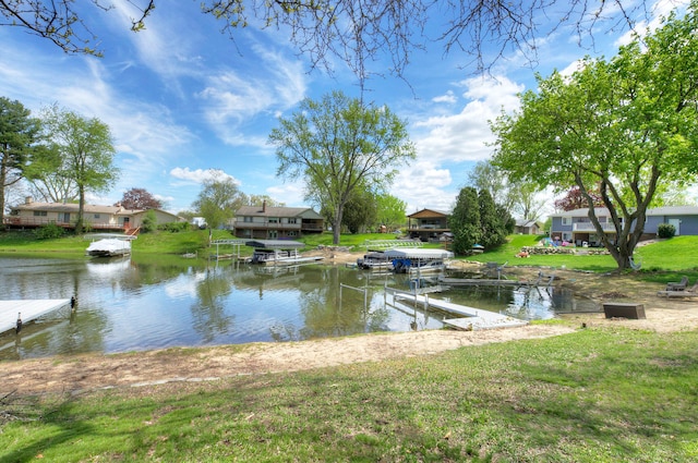 water view with a boat dock and nearby suburban area