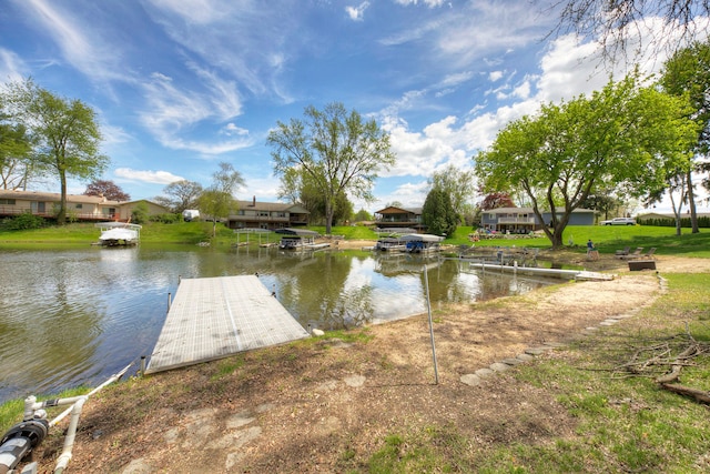 water view with a boat dock and nearby suburban area