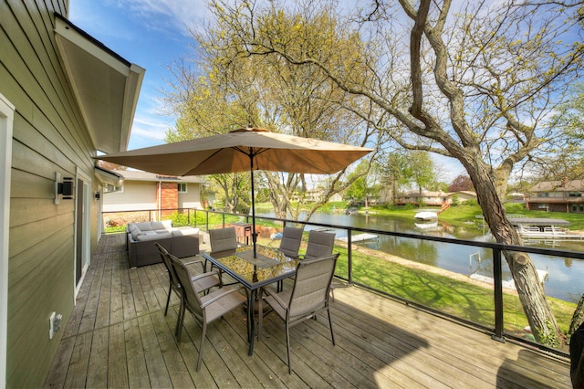 wooden terrace with outdoor lounge area, a water view, and outdoor dining area
