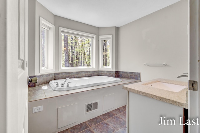 bathroom with a sink and a garden tub