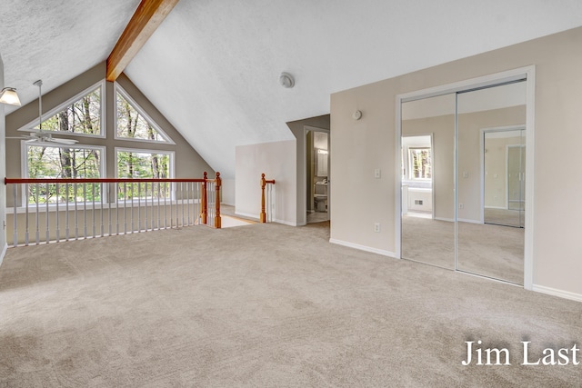 additional living space with healthy amount of natural light, carpet, and baseboards
