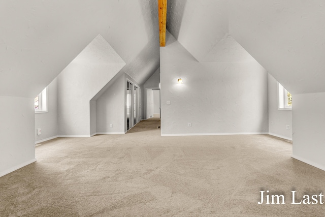 bonus room with lofted ceiling, carpet flooring, healthy amount of natural light, and baseboards