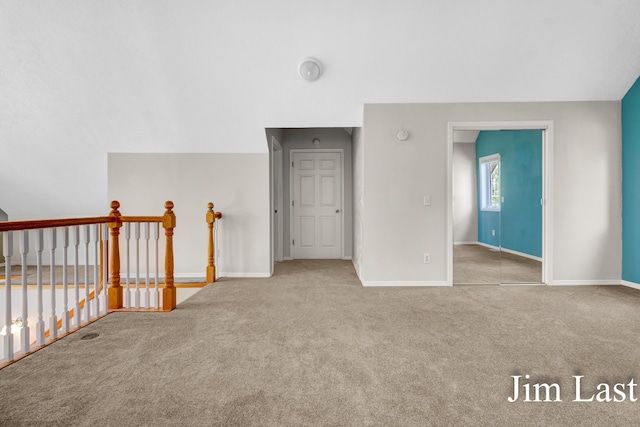 carpeted spare room with baseboards