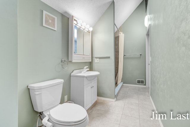 bathroom featuring a stall shower, toilet, vanity, tile patterned floors, and baseboards