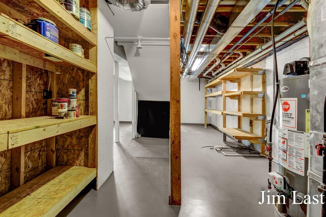unfinished basement featuring water heater