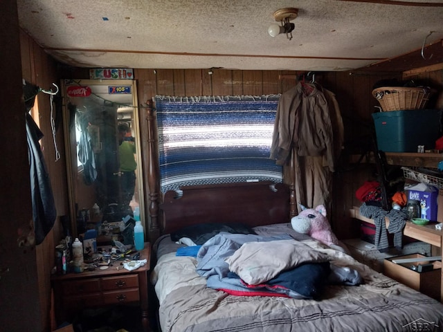1677 S Sumac Ave, White Cloud, MI 49349 - bedroom featuring wood walls and a textured ceiling