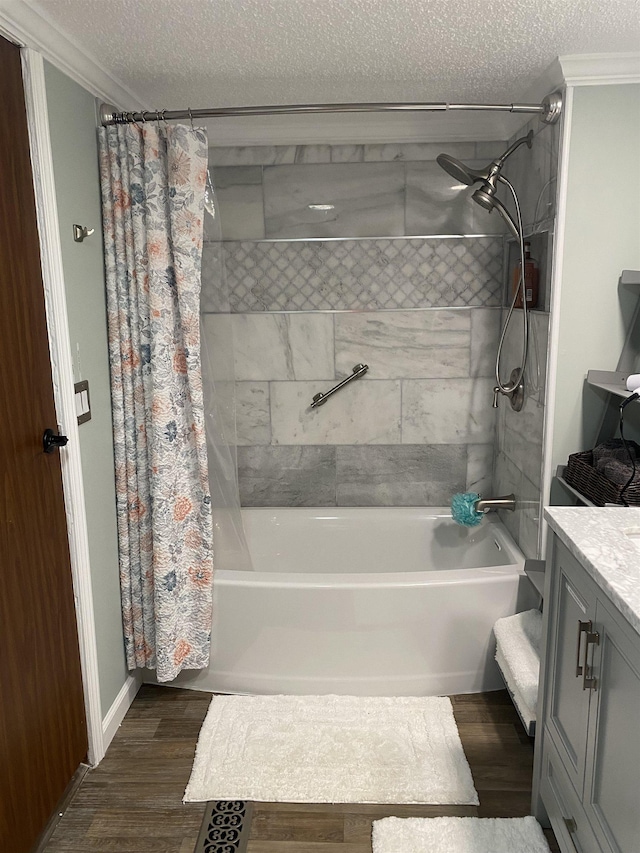 11930 State Rd, Cadillac, MI 49601 - full bathroom featuring a textured ceiling, shower / tub combo, wood finished floors, ornamental molding, and vanity