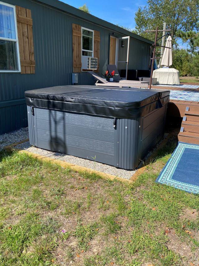 11930 State Rd, Cadillac, MI 49601 - rear view of house featuring a hot tub and cooling unit