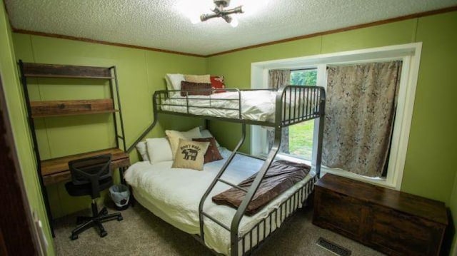 11930 State Rd, Cadillac, MI 49601 - bedroom with ornamental molding, a textured ceiling, and carpet