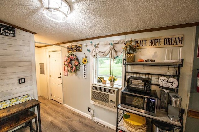 11930 State Rd, Cadillac, MI 49601 - kitchen with stainless steel microwave, a textured ceiling, wood finished floors, cooling unit, and baseboards