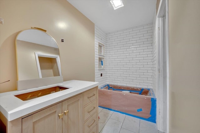 bathroom with tile patterned floors and vanity
