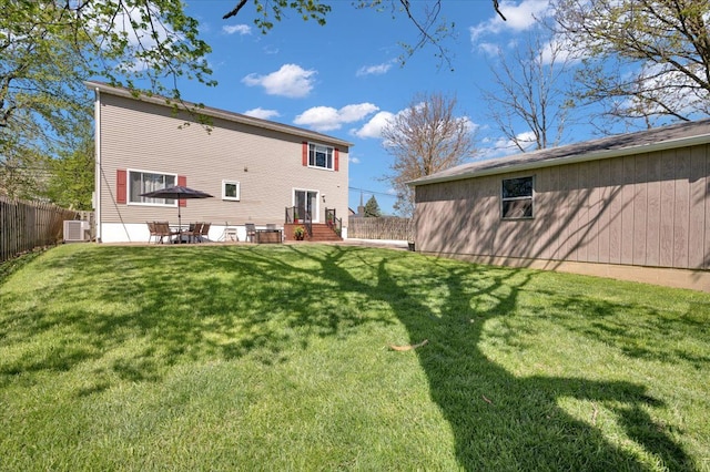 back of property with central AC