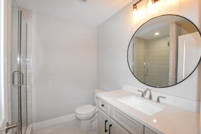 bathroom with a shower stall, tile patterned flooring, vanity, toilet, and baseboards