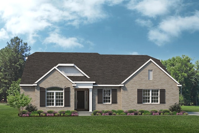 view of front of house with brick siding, a front lawn, and a shingled roof