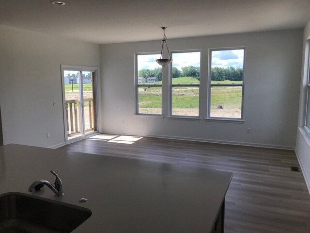 5630 Fir Ct, Almont, MI 48003 - unfurnished dining area with a sink, dark wood-style flooring, recessed lighting, and baseboards