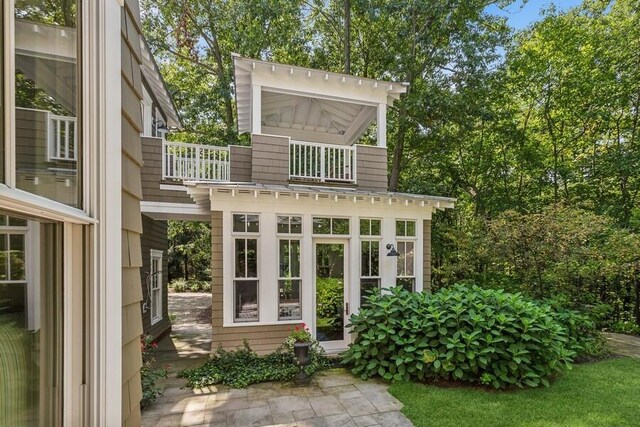 back of property featuring a balcony