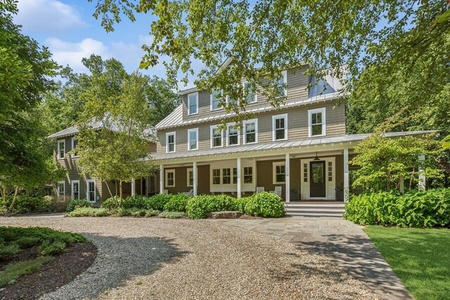 view of front of property featuring covered porch, a standing seam roof, and metal roof