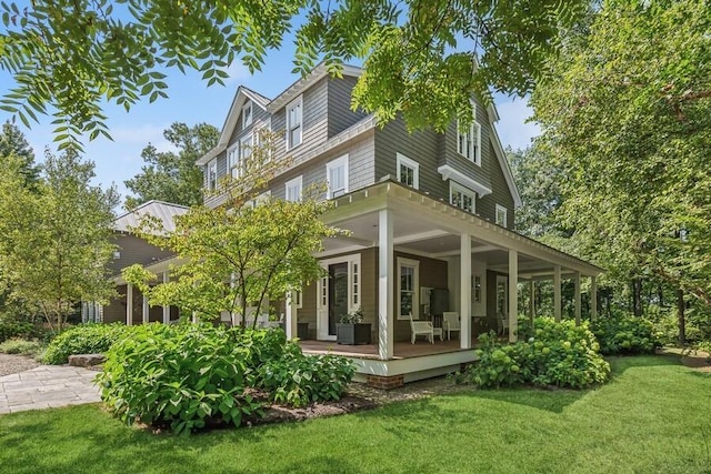 rear view of house featuring a yard