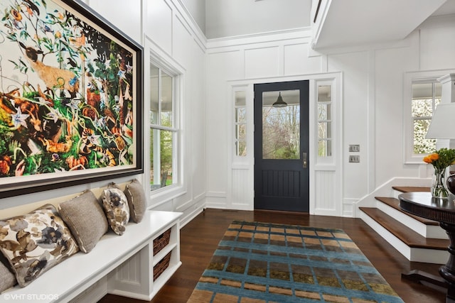 entrance foyer featuring a decorative wall and dark wood-style floors