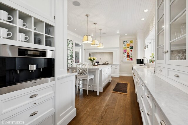 kitchen with crown molding, dark wood-style flooring, white cabinetry, glass insert cabinets, and recessed lighting