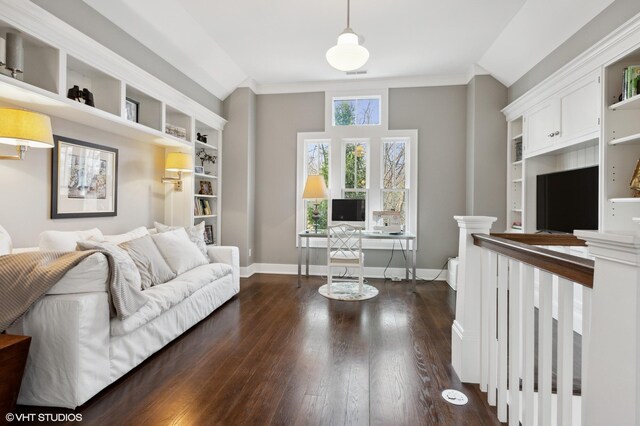 living room featuring a desk, dark wood-style floors, baseboards, and built in shelves