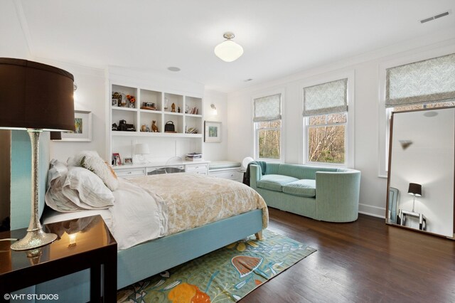 bedroom featuring wood finished floors and ornamental molding