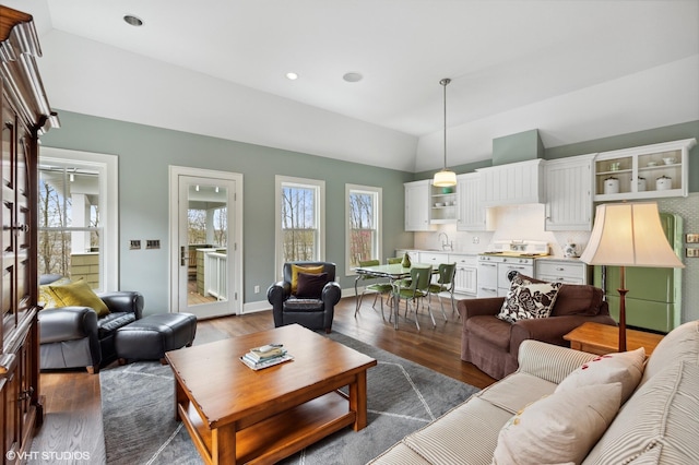 living room with dark wood-style floors, lofted ceiling, and recessed lighting