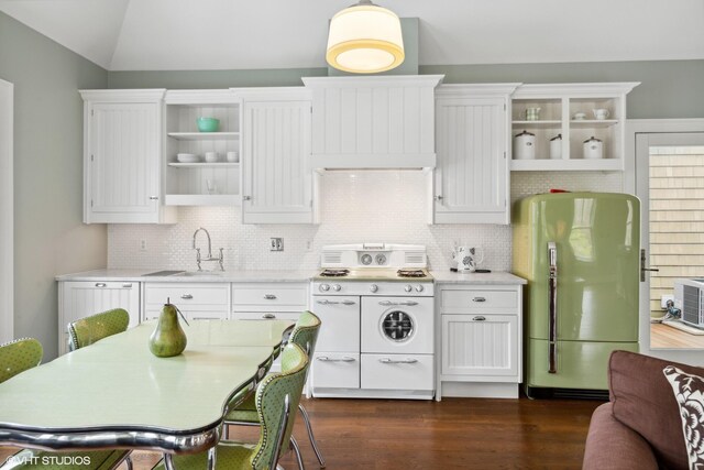 kitchen with freestanding refrigerator, open shelves, white range with gas cooktop, a sink, and white cabinetry
