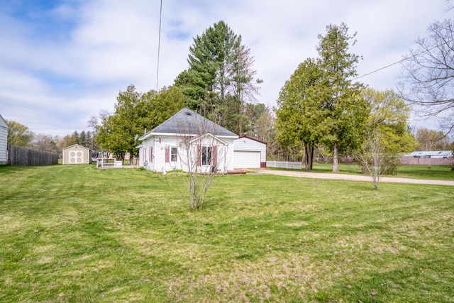 321 N Norman St, Barryton, MI 49305 - view of yard with an outbuilding, concrete driveway, and a storage shed