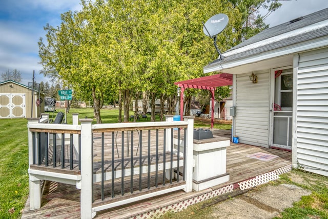 321 N Norman St, Barryton, MI 49305 - wooden deck featuring a shed, a pergola, an outdoor structure, and a lawn