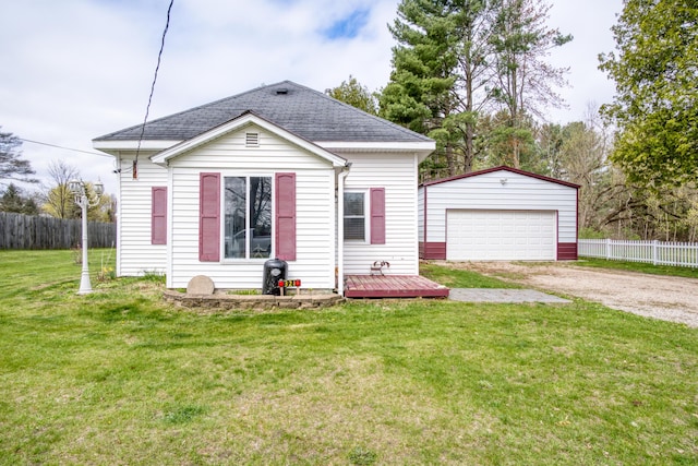 321 N Norman St, Barryton, MI 49305 - view of front of property featuring an outdoor structure, a detached garage, a shingled roof, and a wooden deck