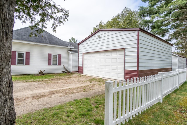 321 N Norman St, Barryton, MI 49305 - detached garage with fence and dirt driveway