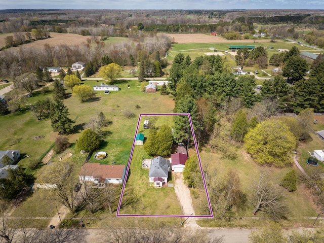 321 N Norman St, Barryton, MI 49305 - aerial overview of property's location featuring property boundaries highlighted and a tree filled landscape