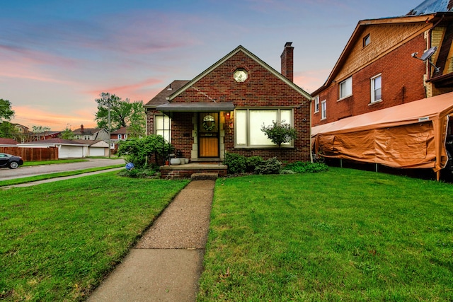 3901 Bedford St, Detroit, MI 48224 - view of front facade with brick siding, a front yard, and a chimney