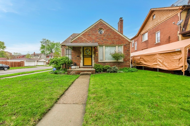 3901 Bedford St, Detroit, MI 48224 - bungalow with brick siding, a front lawn, and a chimney