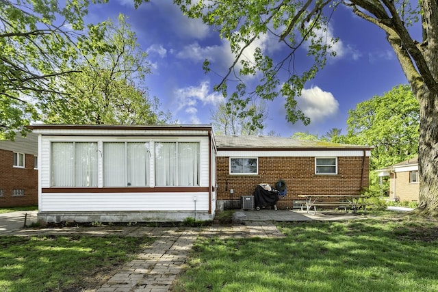 1620 Whittier Rd, Ypsilanti, MI 48197 - back of property featuring a patio, a yard, brick siding, and cooling unit