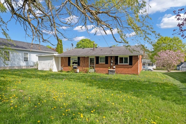 3935 Orr Dr, North Branch, MI 48461 - rear view of property with brick siding and a lawn