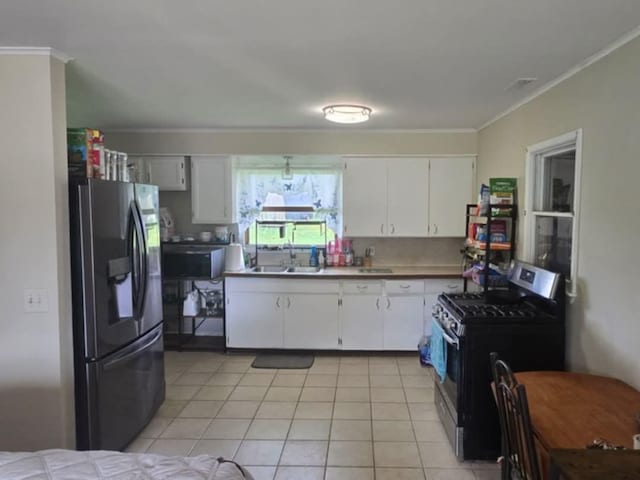 3935 Orr Dr, North Branch, MI 48461 - kitchen with fridge with ice dispenser, stainless steel range with gas stovetop, a sink, ornamental molding, and white cabinetry