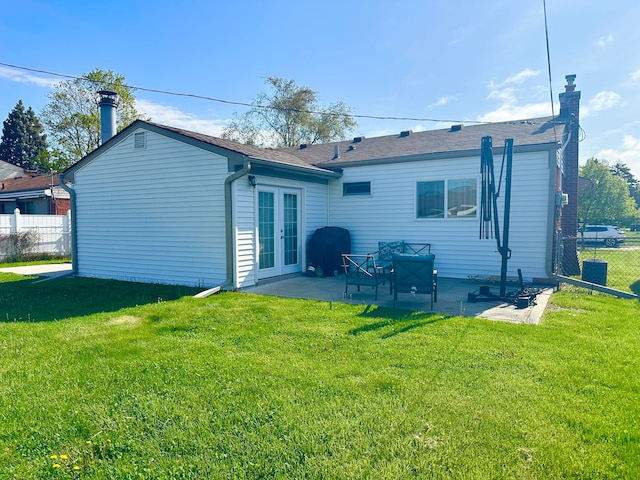 41371 Hamilton Dr, Sterling Heights, MI 48313 - rear view of property featuring french doors, a patio, a chimney, and a shingled roof