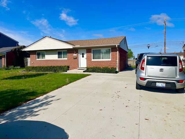 41371 Hamilton Dr, Sterling Heights, MI 48313 - view of front of property with brick siding, a front lawn, and concrete driveway