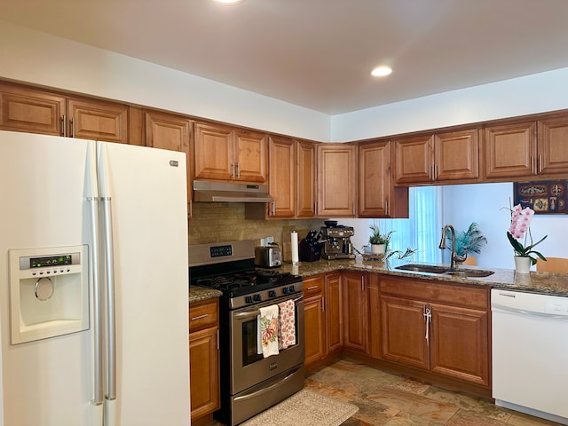 41371 Hamilton Dr, Sterling Heights, MI 48313 - kitchen featuring white appliances, a sink, under cabinet range hood, brown cabinetry, and dark stone counters