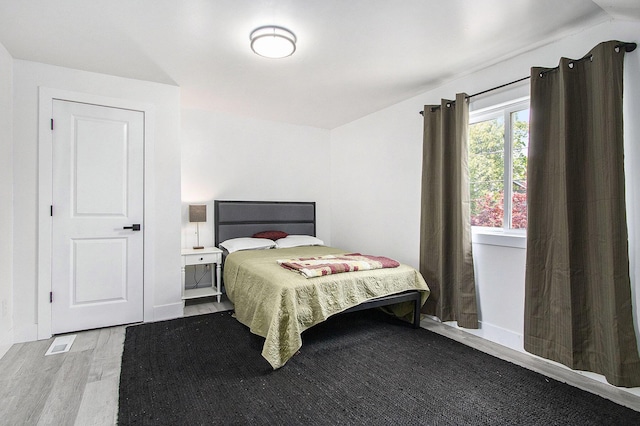bedroom featuring wood finished floors and baseboards